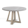 Round dining table with gray top and wooden legs on a white background. Rowan Round Dining Table available at Rustic Ranch Furniture and Decor.
