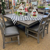 Dining table set with chairs and a checkered tablecloth in a store setting. Homestead Hills 60" Square Table available at Rustic Ranch Furniture and Decor.