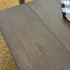 Close-up of a textured brown tabletop. Homestead Hills 60" Square Table available at Rustic Ranch Furniture and Decor.