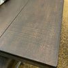 Close-up of a textured dark brown table top. Homestead Hills 60" Square Table available at Rustic Ranch Furniture and Decor.