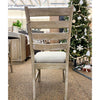 Wooden chair with a cushioned seat in a room. Evy Ladderback Dining Chair available at Rustic Ranch Furniture and Decor.