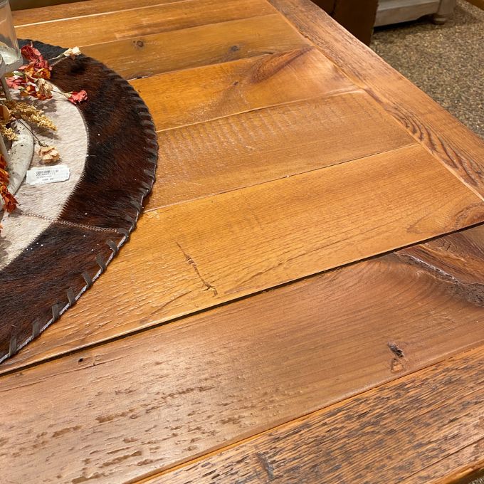 Close-up of a wooden coffee table with a decorative item on top. Sequoia Coffee Table available at Rustic Ranch Furniture and Decor.