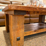 Wooden coffee table in a room with leather furniture. Sequoia Coffee Table available at Rustic Ranch Furniture and Decor.