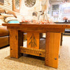 Wooden coffee table with a decorative design in a store setting. Sequoia Coffee Table available at Rustic Ranch Furniture and Decor.