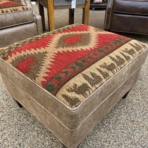 Rectangular ottoman with a patterned cushion featuring deer designs in a store setting. Charles ottoman available at Rustic RAnch Furniture and Decor.