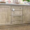 Wooden cabinet with drawers and doors on a countertop. Rowan Buffet available at Rustic Ranch Furniture and Decor.