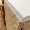 Close-up of a wooden cabinet with a white countertop. Rowan Buffet available at Rustic Ranch Furniture and Decor.