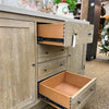 Wooden cabinet with open drawers in a store setting. Rowan Buffet available at Rustic Ranch Furniture and Decor.