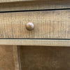Close-up of a wooden drawer with a knob. Beach Pebble Side Table available at Rustic Ranch Furniture and Decor.