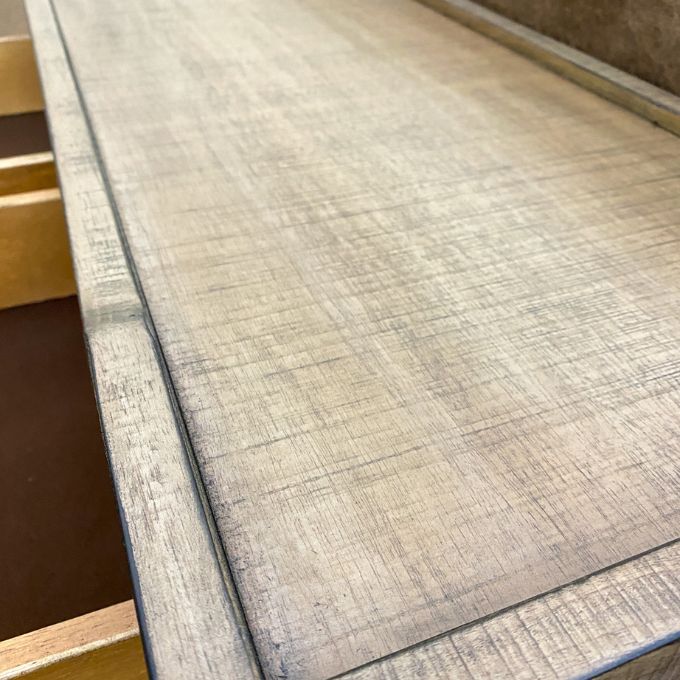 Close-up of the top of a side table with a neutral color palette. Beach Pebble Side Table available at Rustic Ranch Furniture and Decor.