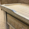 Close up of wooden side table with  distressed top. Beach Pebble Side Table available at Rustic Ranch Furniture and Decor.
