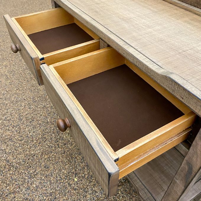 Wooden drawer with brown microfibre interior on a wooden surface. Beach Pebble Side Table available at Rustic Ranch Furniture and Decor.