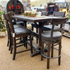 Dark wood dining table with six bar stools in a store setting. Homestead Pub Table available at Rustic Ranch Furniture and Decor.