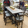 Dining table set with chairs in a store setting. Homestead Pub Table available at Rustic Ranch Furniture and Decor.