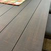 Close-up of a dark wooden table surface. Homestead Pub Table available at Rustic Ranch Furniture and Decor.