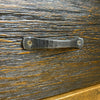 Hand forged iron handle on a wooden surface. Fireside Nightstand available at Rustic Ranch Furniture and Decor.