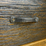 Hand forged iron handle on a wooden surface. Fireside Nightstand available at Rustic Ranch Furniture and Decor.