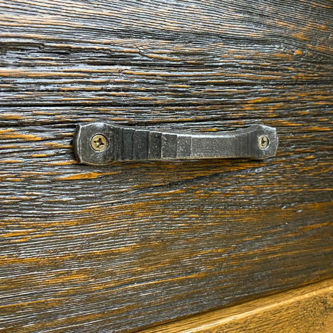 Hand forged iron handle on a wooden surface. Fireside Nightstand available at Rustic Ranch Furniture and Decor.