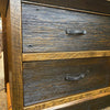 Wooden dresser with two drawers and metal handles on a textured surface. Fireside Nightstand available at Rustic Ranch Furniture and Decor.