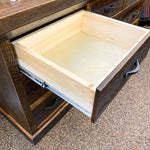 Wooden drawer with a metal handle on a wooden cabinet. Fireside Reclaimed Wood Seven Drawer Dresser available at Rustic Ranch Furniture and Decor.
