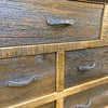 Close-up of a wooden drawer with metal handles. Fireside Reclaimed Wood Seven Drawer Dresser available at Rustic Ranch Furniture and Decor.