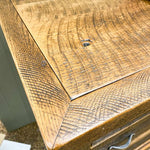 Close-up of a wooden surface with visible grain and texture. Fireside Reclaimed Wood Seven Drawer Dresser available at Rustic Ranch Furniture and Decor.