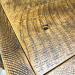 Close-up of wooden surface with visible grain and texture. Fireside Reclaimed Wood Seven Drawer Dresser available at Rustic Ranch Furniture and Decor.
