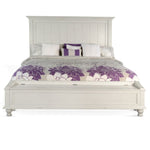 White bed with purple floral bedding on a white background.  Carriage House Bed - King and Queen Sizing available at Rustic Ranch Furniture and Decor.