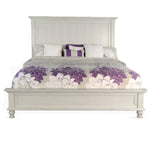 White bed with floral bedding on a white background.  Carriage House Bed - King and Queen Sizing available at Rustic Ranch Furniture and Decor.