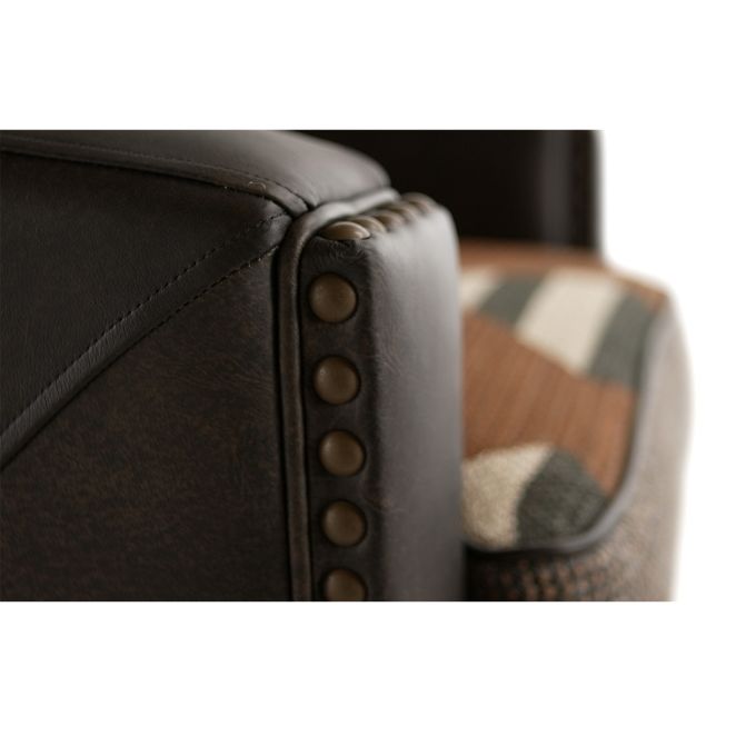 Close-up of a brown leather armchair with buttoned details.  Hollister Chair at Rustic Ranch Furniture and Decor.