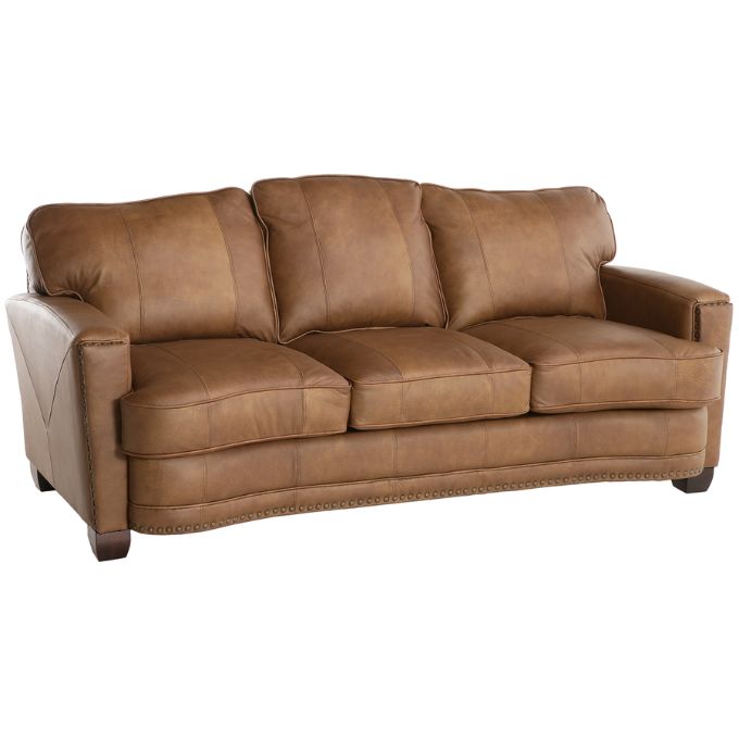 Brown leather sofa on a white background.  The Hollister Sofa is  available at Rustic Ranch Furniture and Decor.