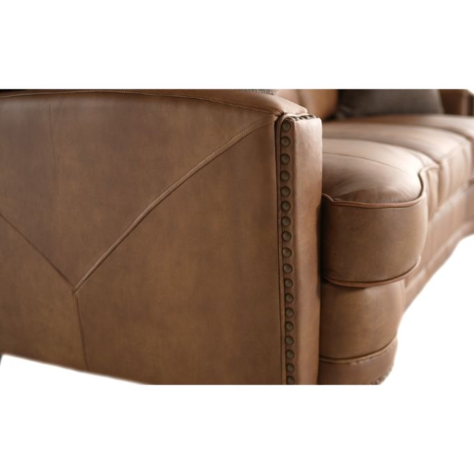 Close-up of a brown leather sofa with visible stitching details.  The Hollister Sofa is available at Rustic Ranch Furniture and Decor.