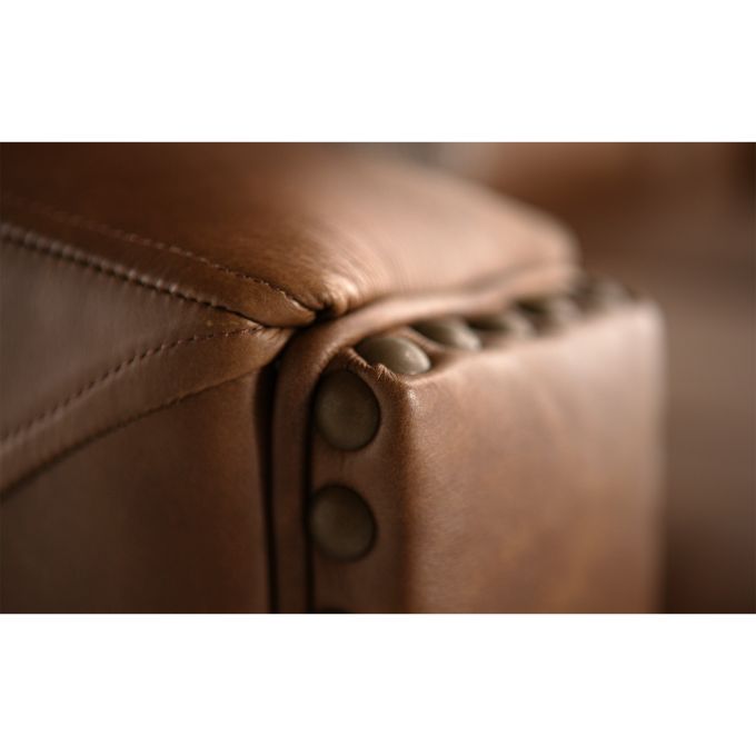 Close-up of brown leather furniture with button details.  The Hollister Sofa is  available at Rustic Ranch Furniture and Decor.