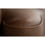 Close-up of a brown leather surface with a subtle texture.   The Hollister Sofa is  available at Rustic Ranch Furniture and Decor.