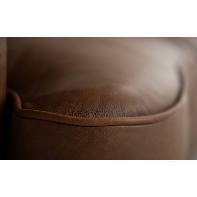 Close-up of a brown leather surface with a subtle texture.   The Hollister Sofa is  available at Rustic Ranch Furniture and Decor.