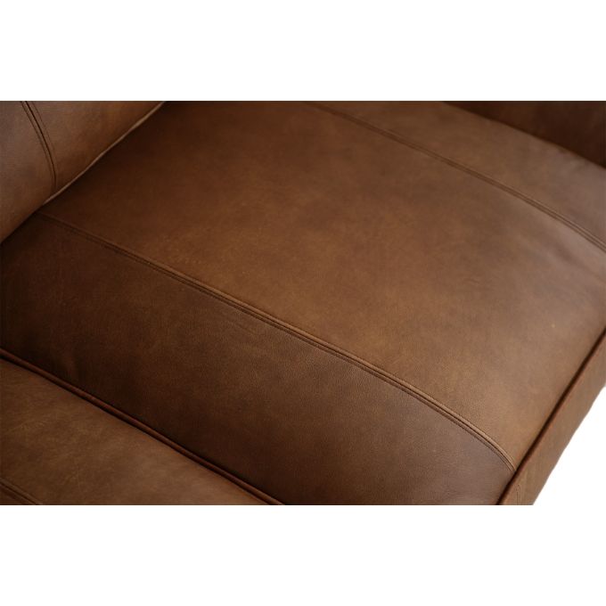 Close-up of a brown leather sofa with visible stitching.  The Hollister Sofa available at Rustic Ranch Furniture and Decor.