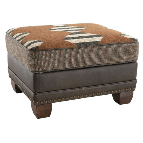 Brown and gray ottoman with patterned cushion on a white background Hollister Ottoman available at Rustic Ranch Furniture and Decor.