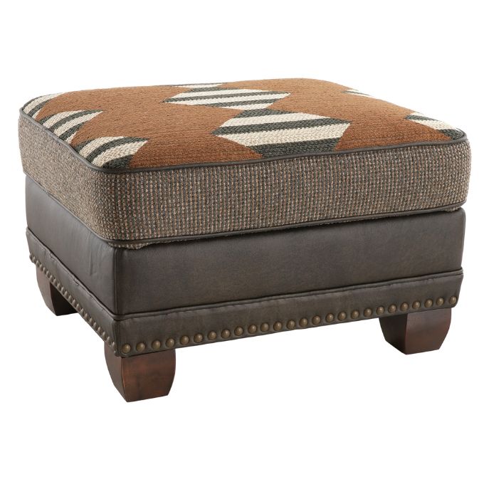 Brown and gray ottoman with patterned cushion on a white background Hollister Ottoman available at Rustic Ranch Furniture and Decor.