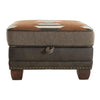 Brown ottoman with patterned top and wooden legs on a white background. Hollister Ottoman available at Rustic Ranch Furniture and Decor.