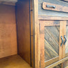 Wooden cabinet with open doors and metal handles in a rustic setting.  Jackson Hole Four Door Sideboard available at Rustic Ranch Furniture and Decor.