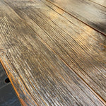 Close-up of a wooden surface with visible grain and texture.  Jackson Hole Four Door Sideboard available at Rustic Ranch Furniture and Decor.