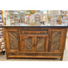 Wooden sideboard with decorative items. Jackson Hole Four Door Sideboard available at Rustic Ranch Furniture and Decor.