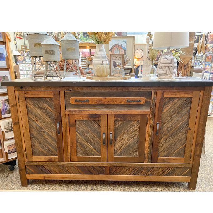 Wooden sideboard with decorative items. Jackson Hole Four Door Sideboard available at Rustic Ranch Furniture and Decor.