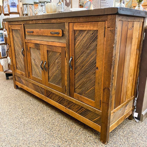 Wooden sideboard with rustic design in a store setting.  Jackson Hole Four Door Sideboard available at Rustic Ranch Furniture and Decor.