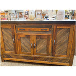 Wooden sideboard in a store setting.  Jackson Hole Four Door Sideboard available at Rustic Ranch Furniture and Decor.