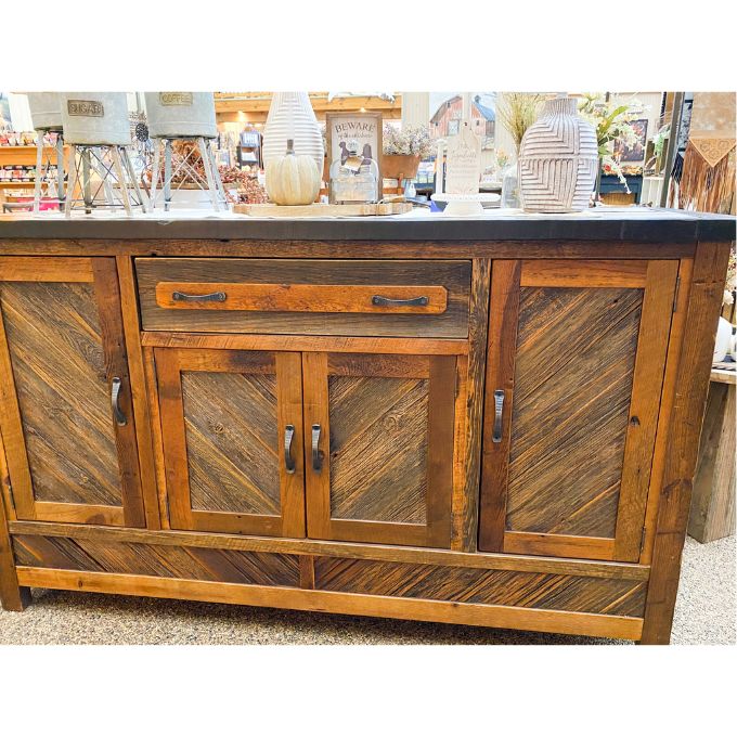 Wooden sideboard with a rustic design in an indoor setting.  Jackson Hole Four Door Sideboard available at Rustic Ranch Furniture and Decor.