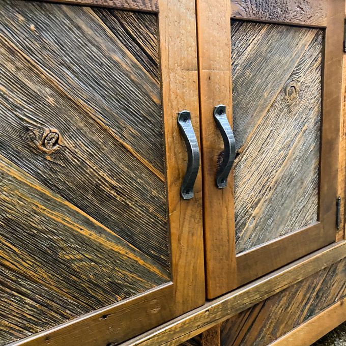 Wooden cabinet with rustic design and metal handles.  Jackson Hole Four Door Sideboard available at Rustic Ranch Furniture and Decor.