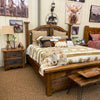Wooden bedroom set with bed, nightstands, and wall art in a room setting. 