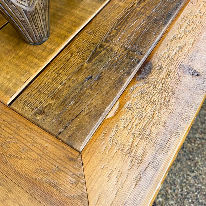 Close-up of a wooden surface with a rustic finish. Black Hills Two Drawer Nightstand available at Rustic Ranch Furniture and Decor.
