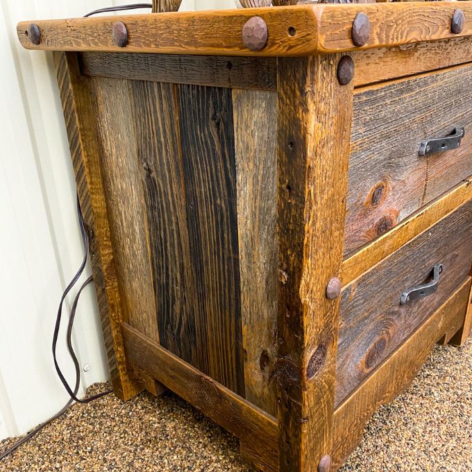 Wooden nightstand with rivets. Black Hills Two Drawer Nightstand available at Rustic Ranch Furniture and Decor.